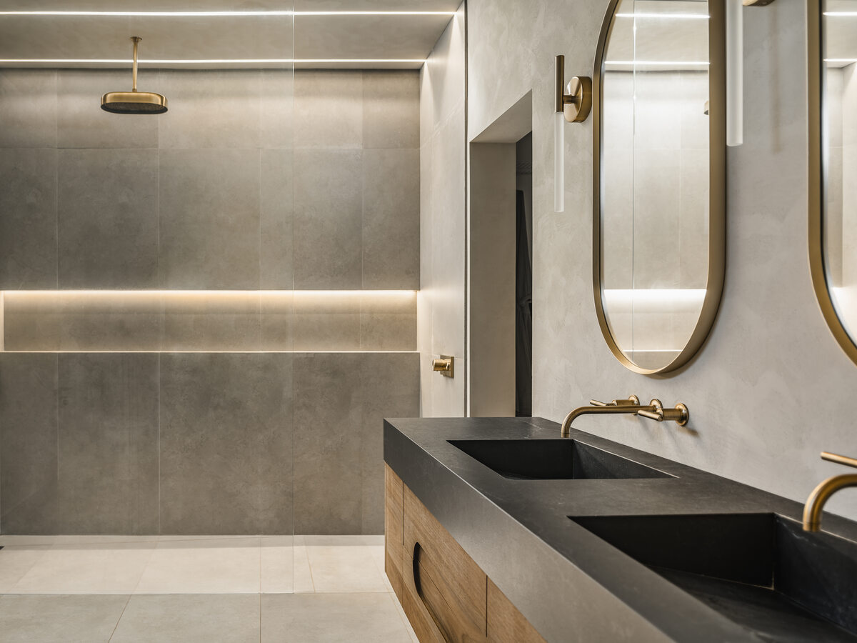 Custom bathroom vanity with brass hardware and tile